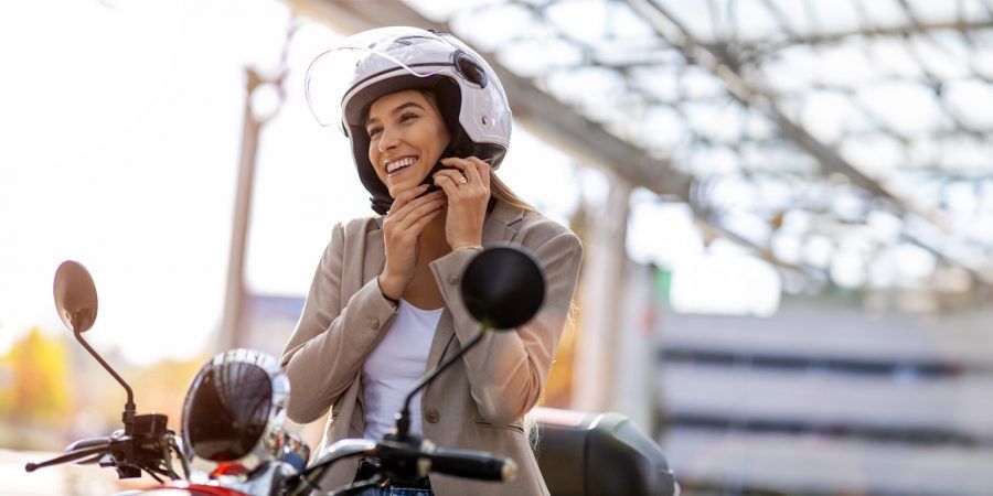 Rapariga coloca capacete depois de ter passado no exame para a carta de condução de moto